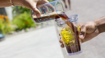 Coffee being poured into a special "Week of Welcome" glass during coffee at the catamount which offers free coffee every hour during Week of Welcome