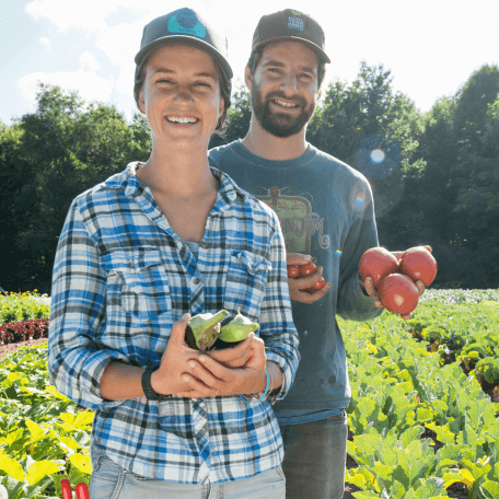 Students show the produce they have grown