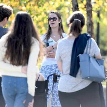 Student giving a campus tour to prospective students and families.