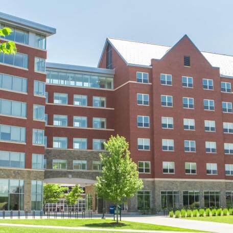 A modern, brick and glass 6-story building. 