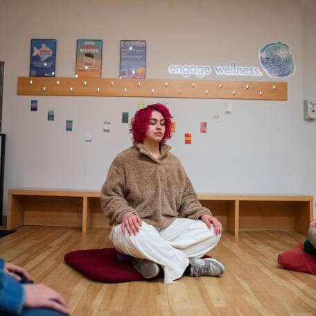 Students meditating in Living Well