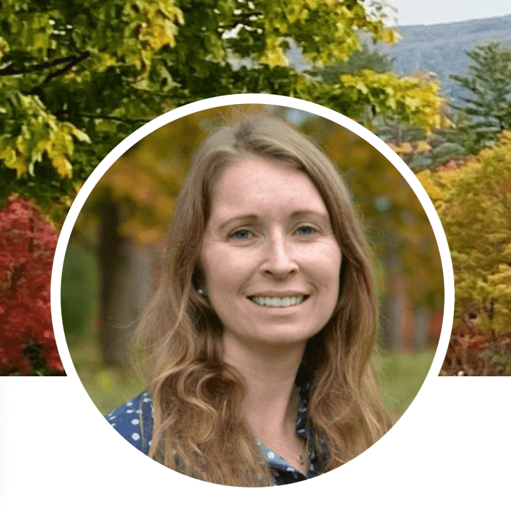 Woman in front of fall foliage