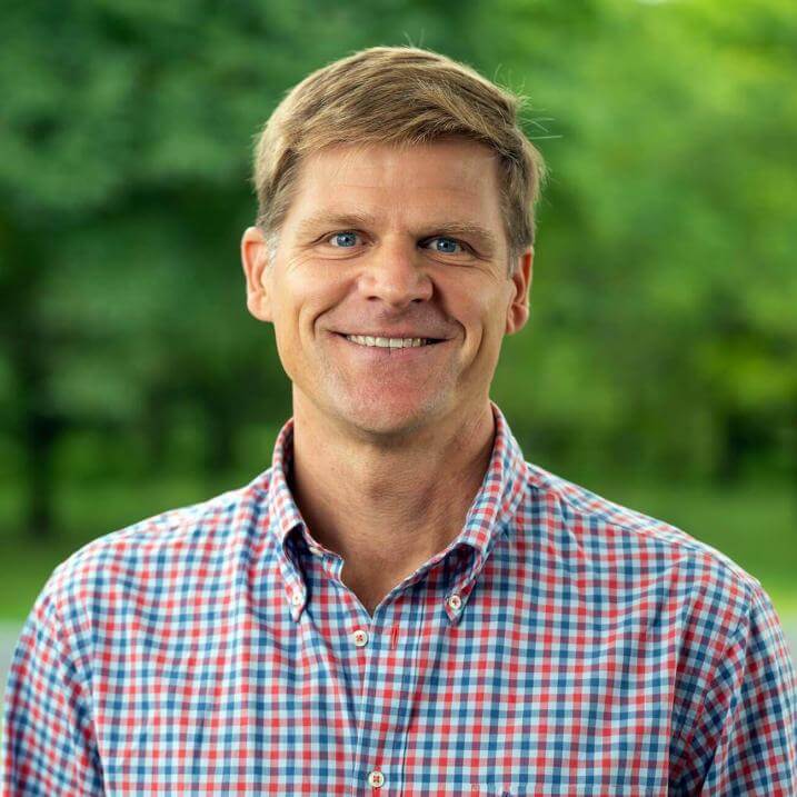 Mark Isselhardt outdoors in warm weather, smiling