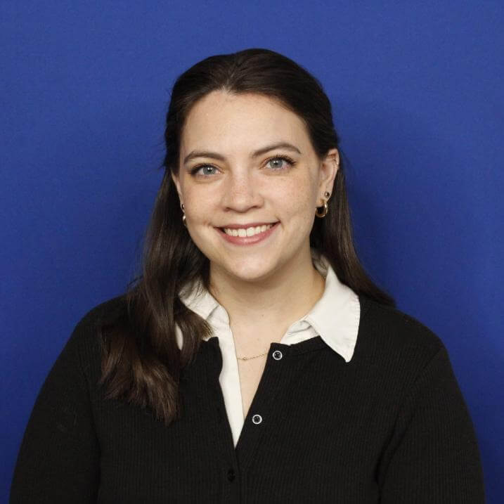 Headshot of Megan - blue backdrop 