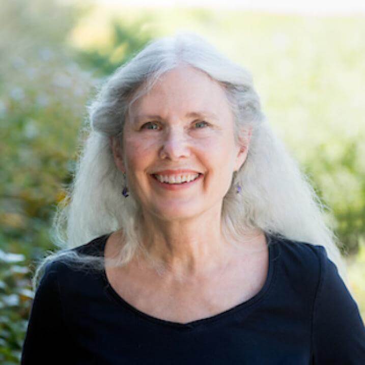 Cathy outdoors smiling at the camera