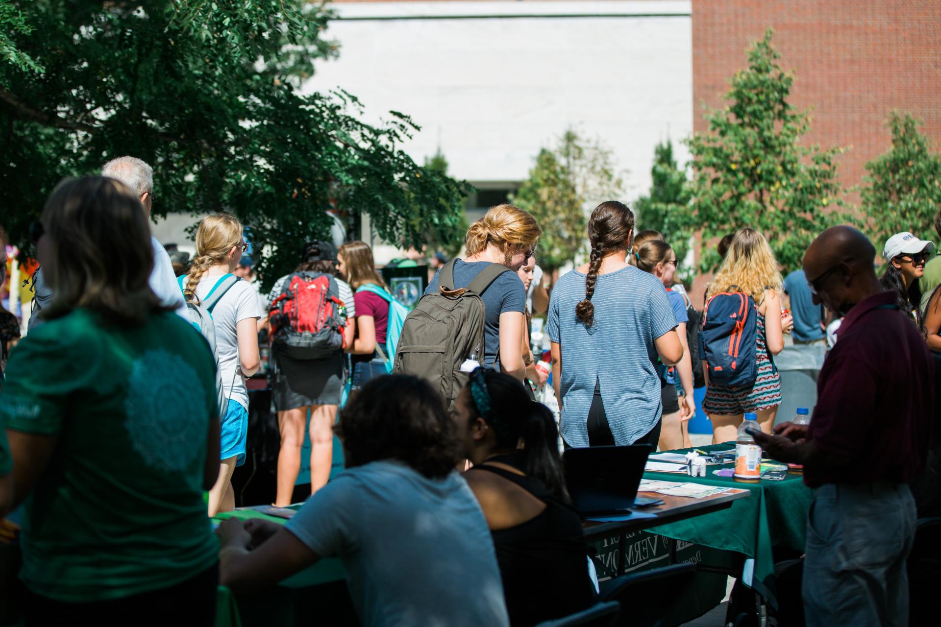 Event tables during the week of welcome interacting with many students and talking amongst one another