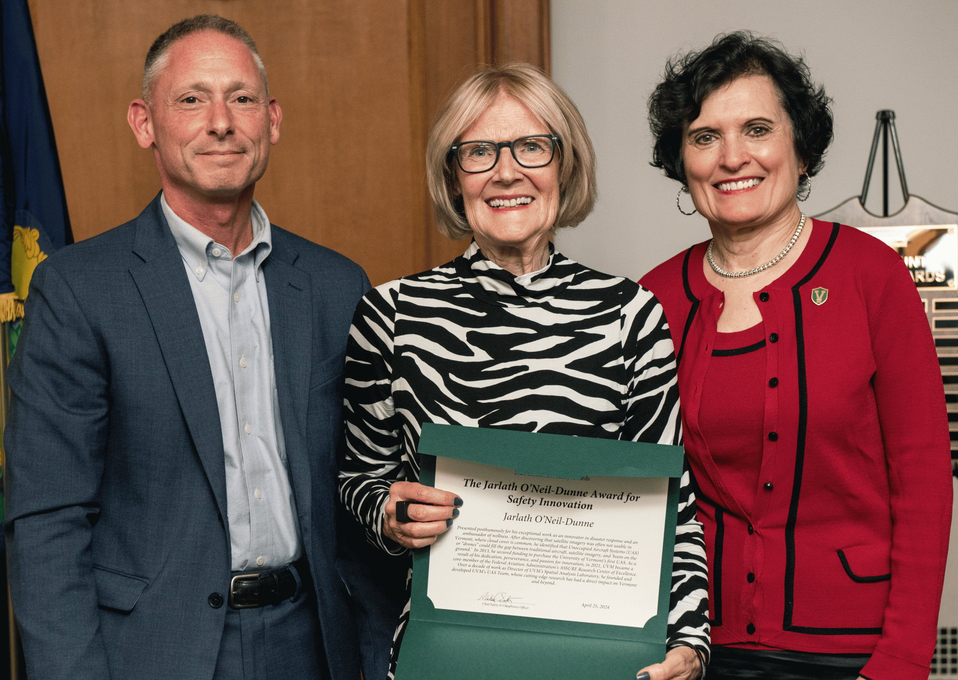 Mairi accepts a posthumous ward for her son, Jarlath O'Neil Dunne, presented by Michael Schirling and Provost Patricia Prelock