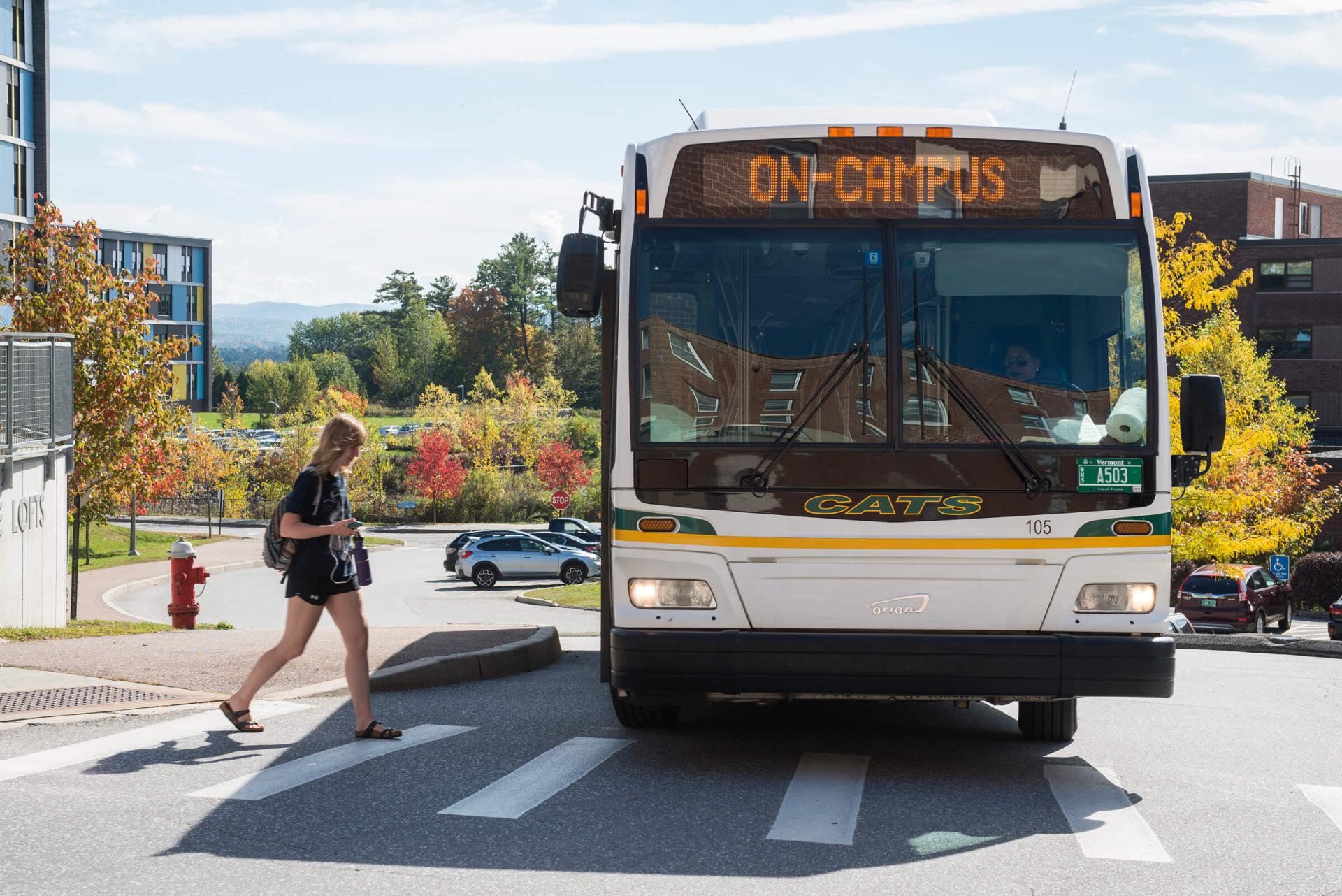 Student boarding the UVM bus on Redstone Campus.
