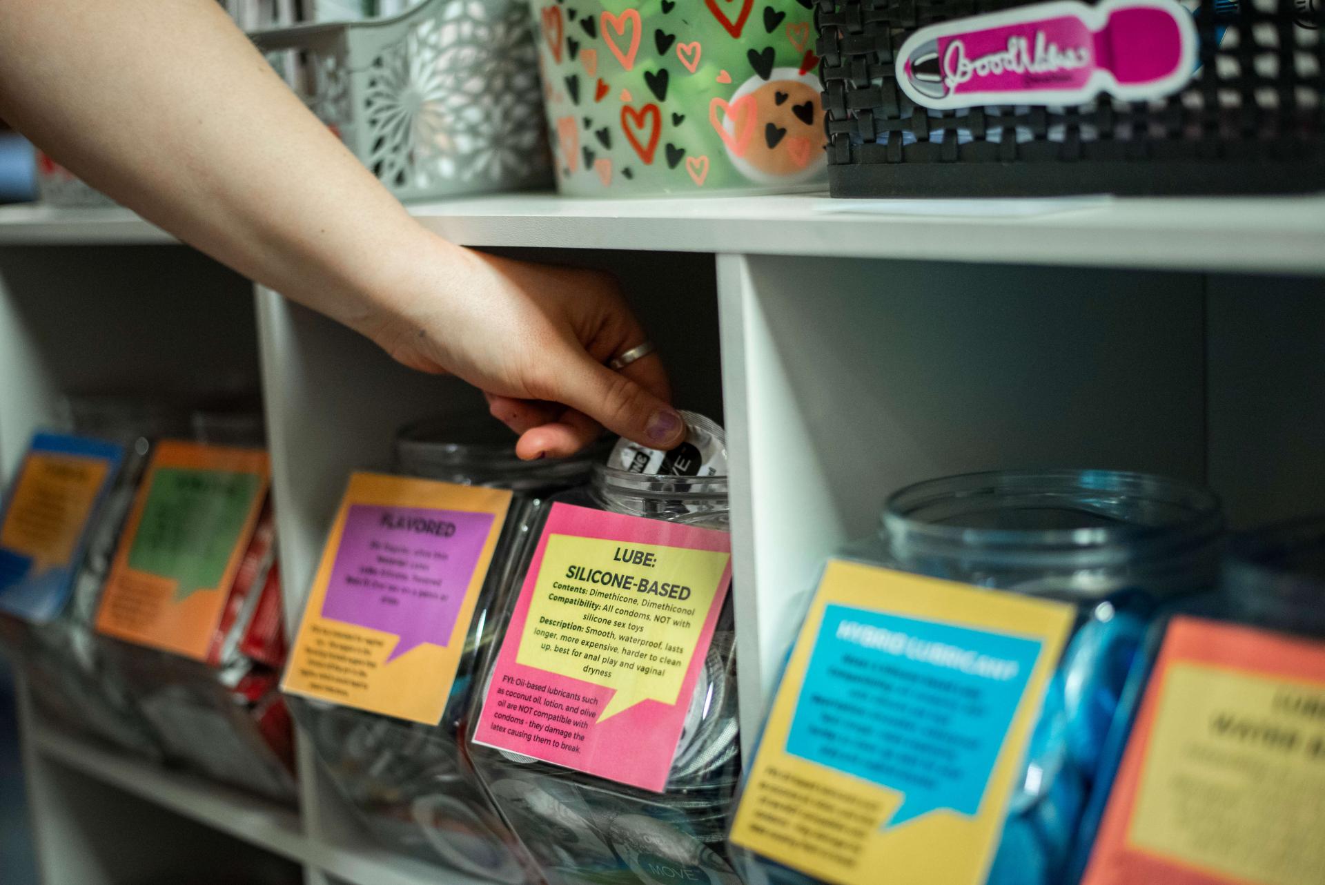 hand reaching into condom container at the condom co-op