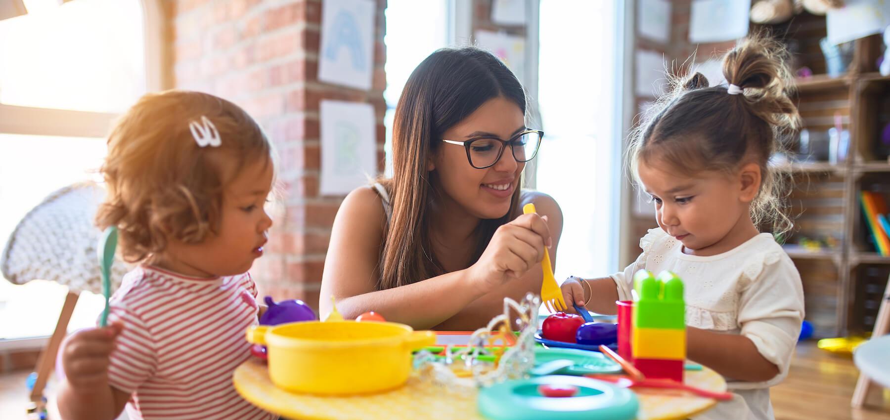 Special educator working with children in a classroom.