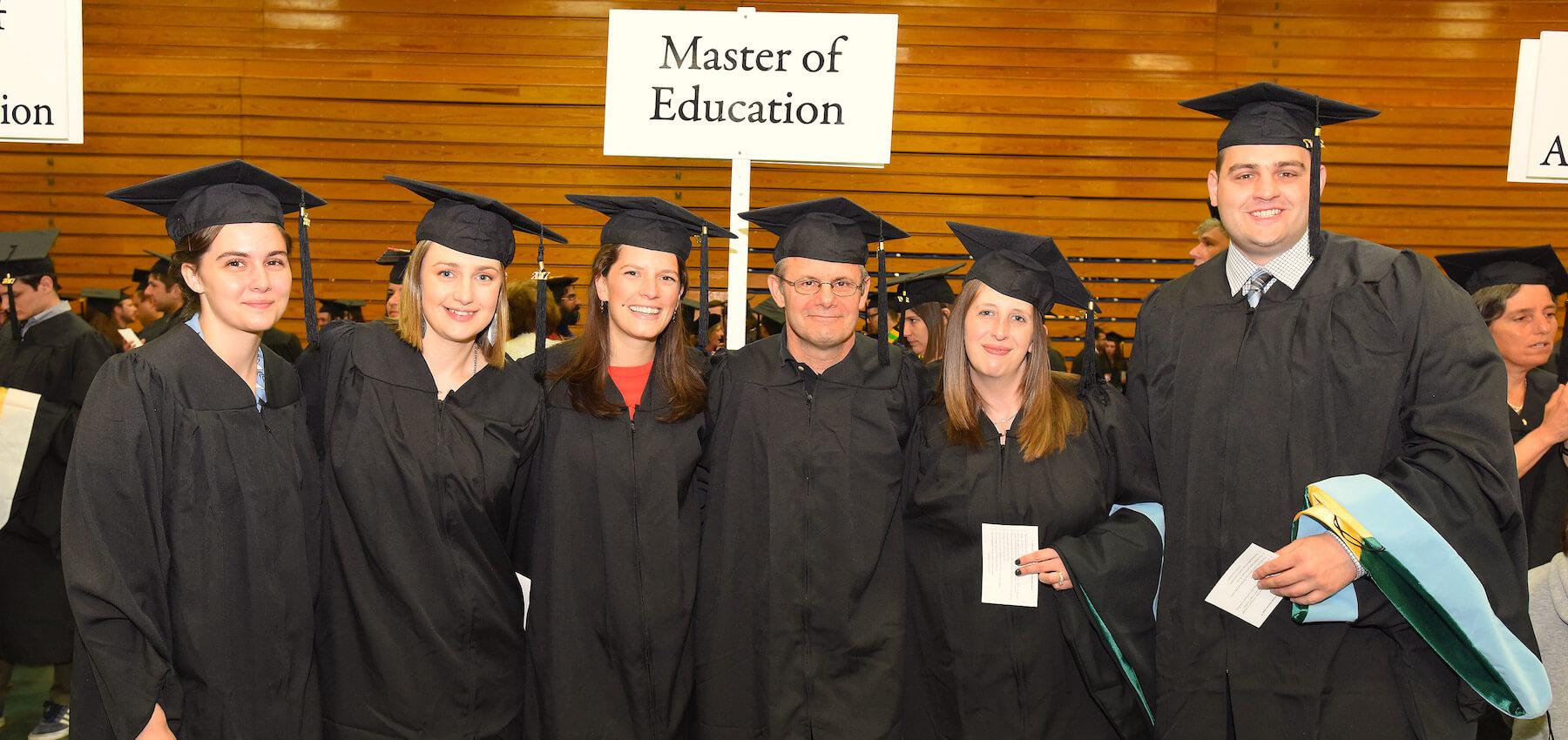 Group of five graduates of the Educational Leadership and Policy Studies M.Ed. at Graduate College Commencement lineup.