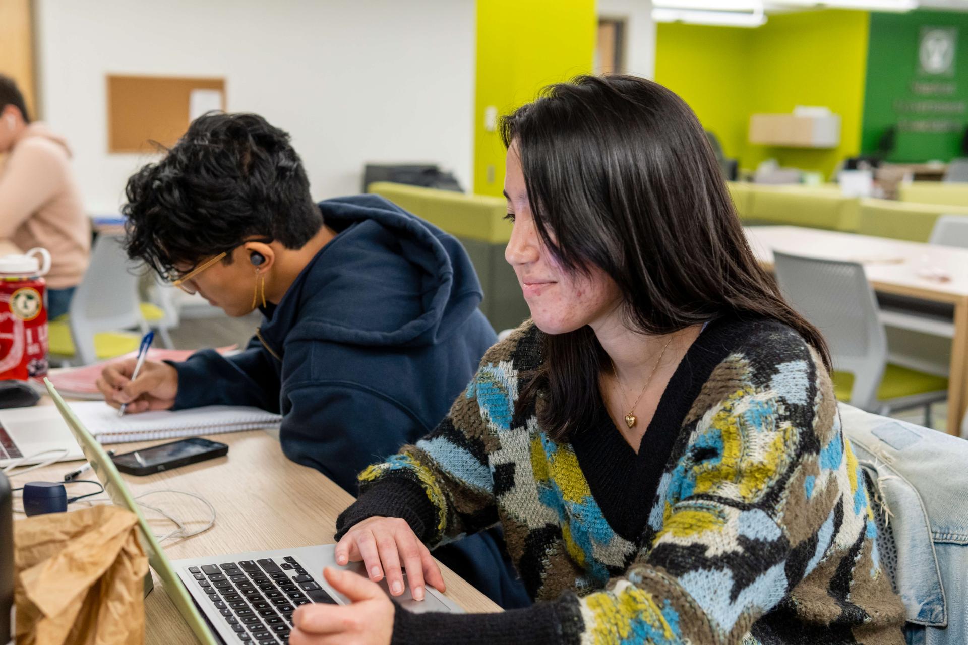 2 students work on their laptops in the SGA Galaxy Space