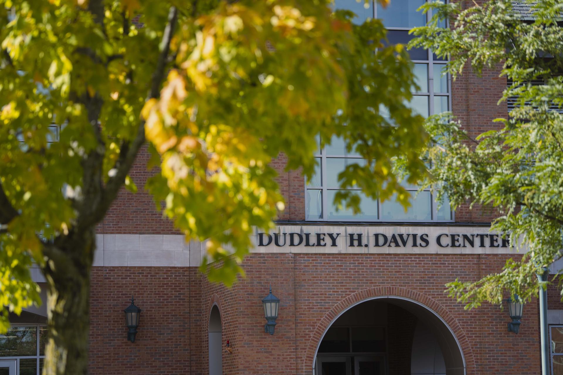 Entrance to Davis Center seen through foliage