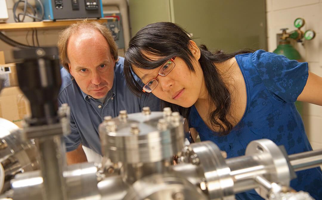 Professor and student working together in Physics lab