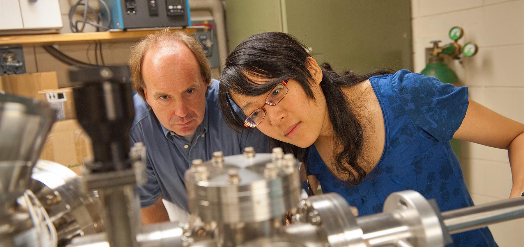 Physics professor and student doing lab research