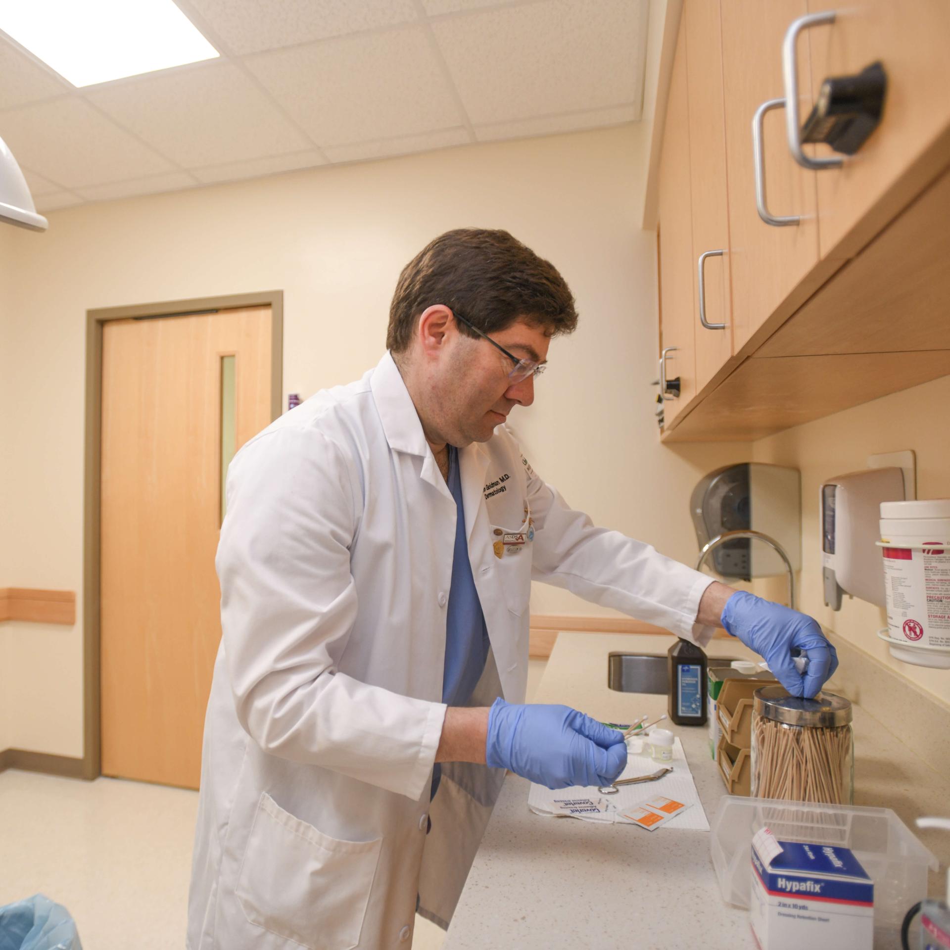A doctor prepares for a patient procedure. 