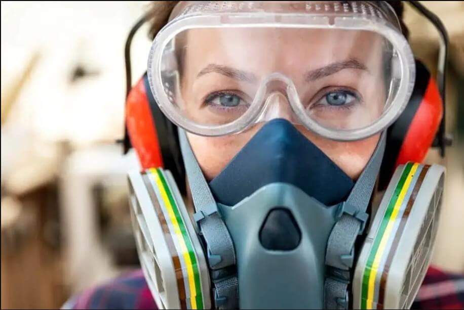 Worker wearing Respirator, Safety Glasses, Hearing Protection