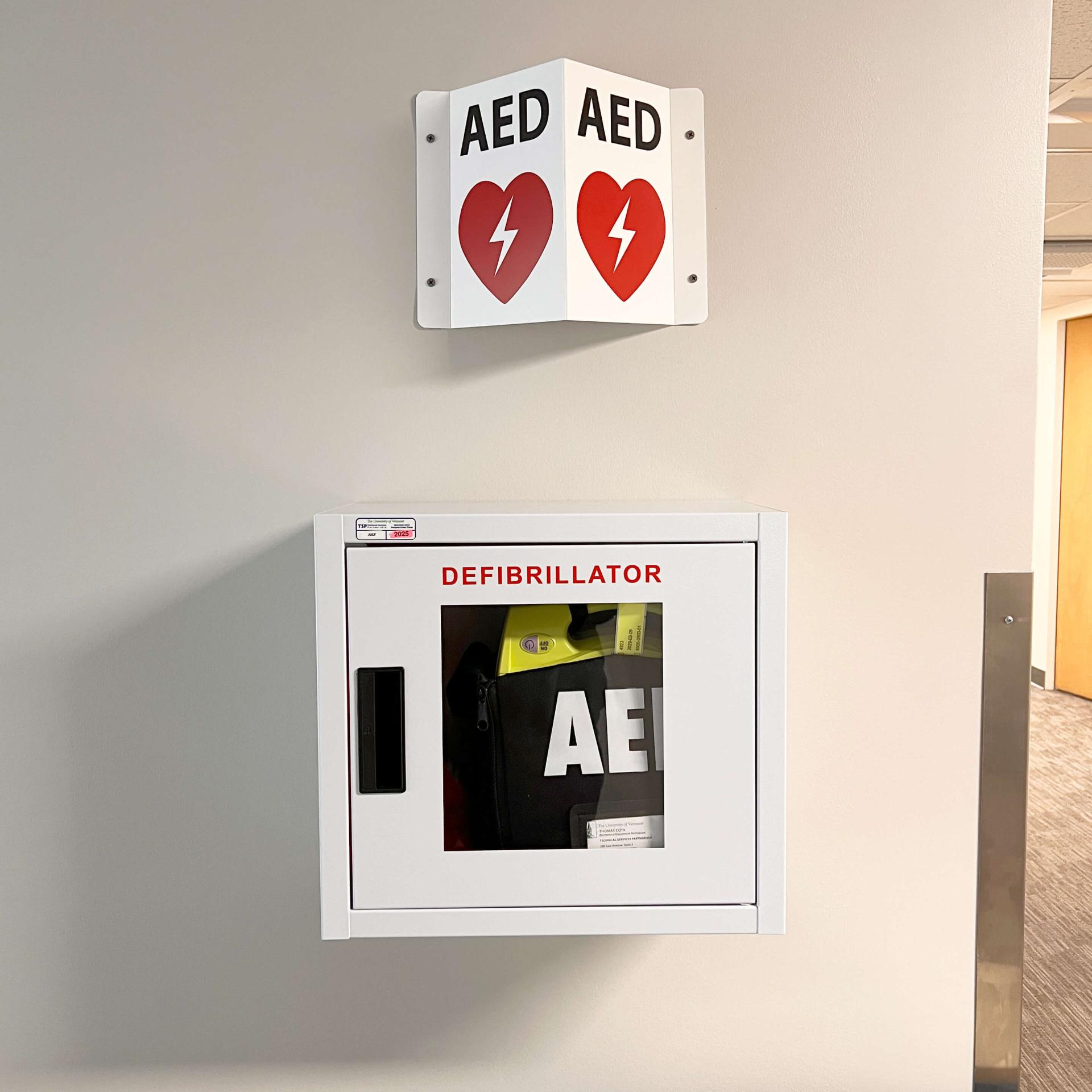 CAT ECare Station with AED mounted on a wall.