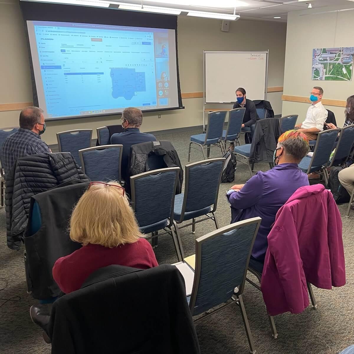 in-person meeting attendees discussing project
