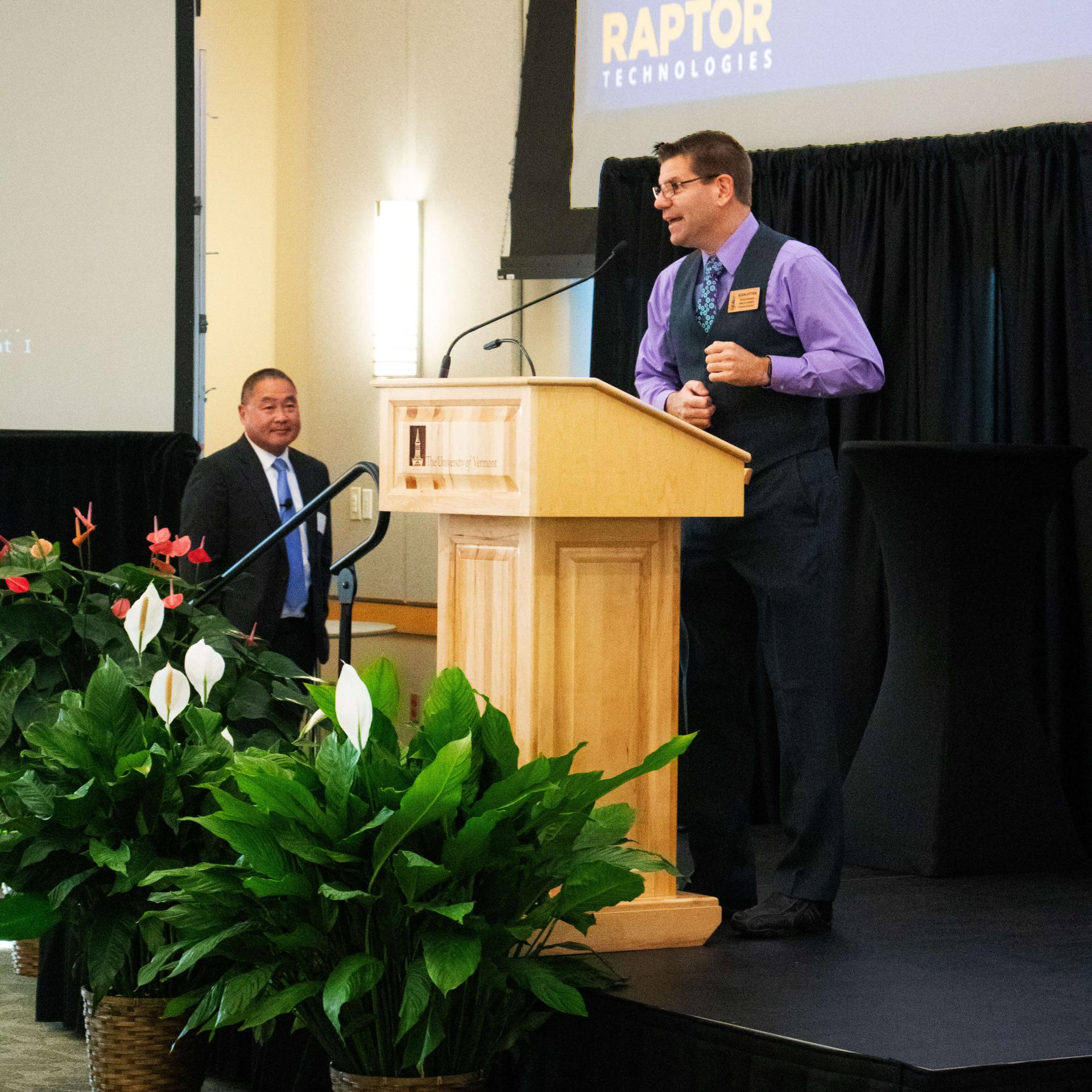 Training Coordinator introduces guest speaker on stage