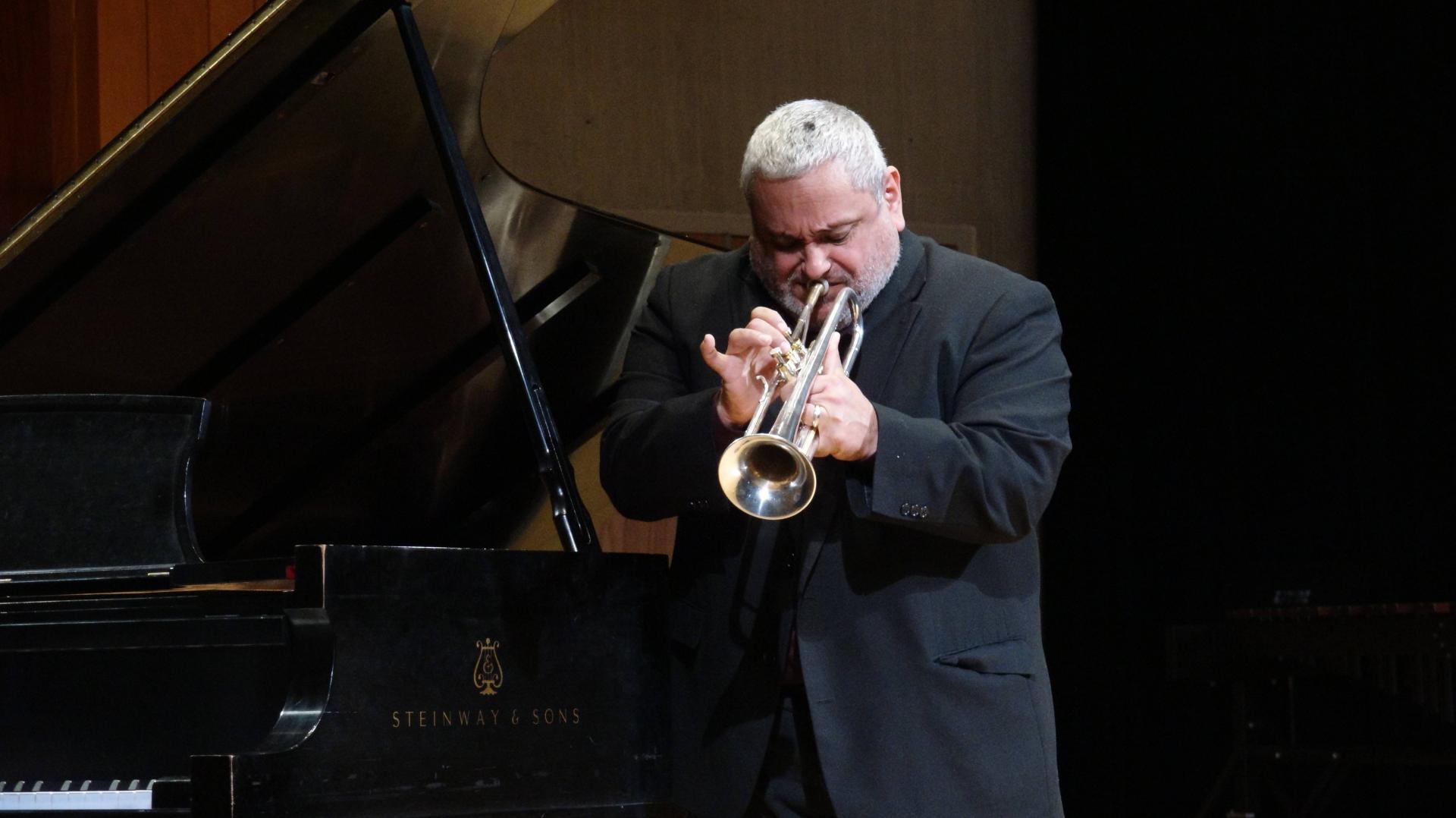 A person playing a instrument on the stage