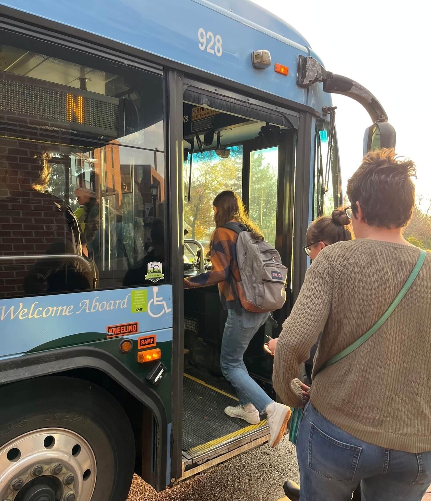 Students at UVM boarding a Green Mountain Transit city bus