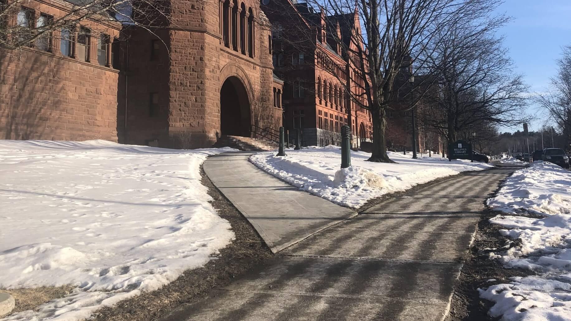 sidewalk with lines of liquid pre-treatment brine