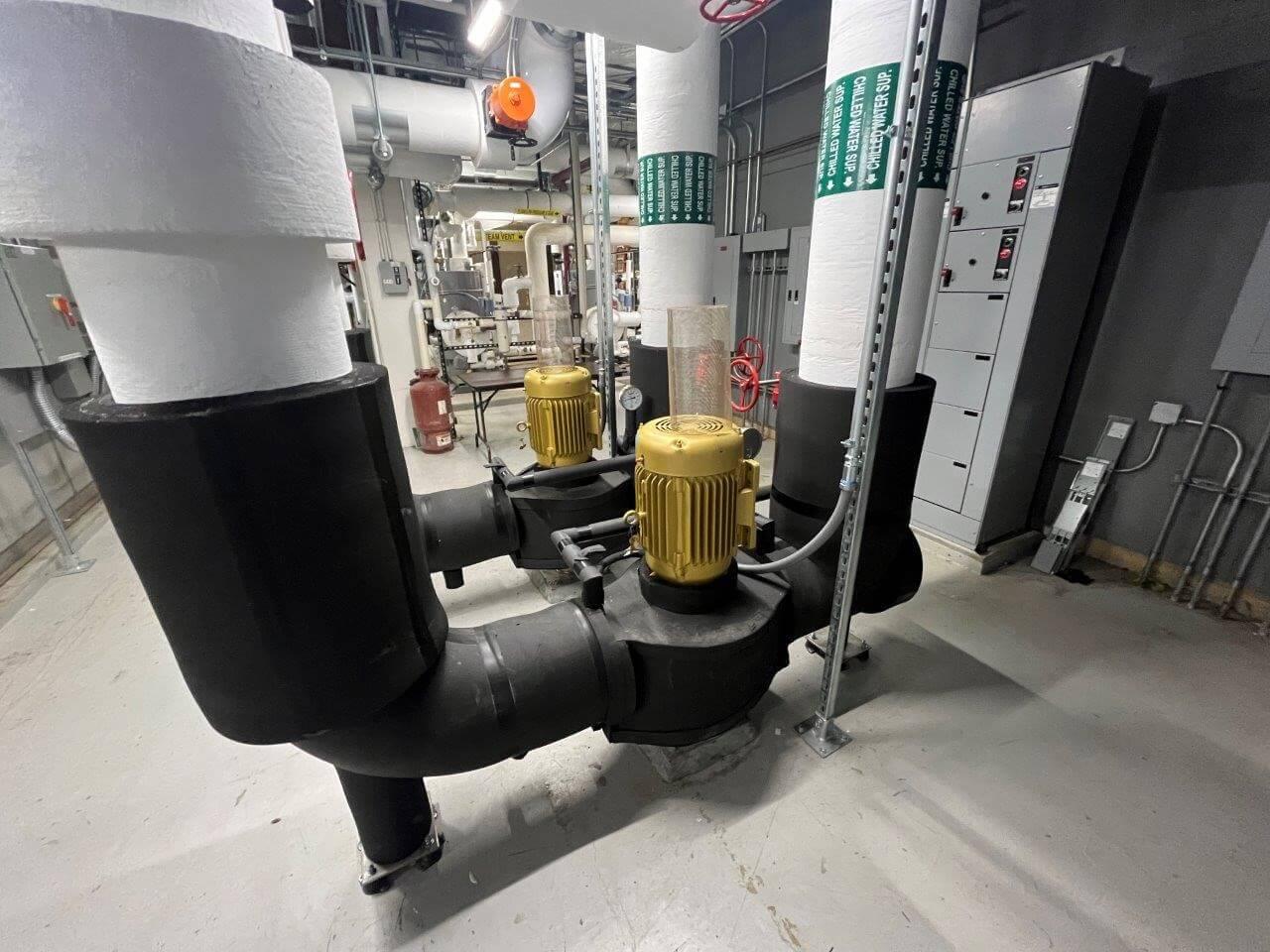 large industrial pumps inside building machine room
