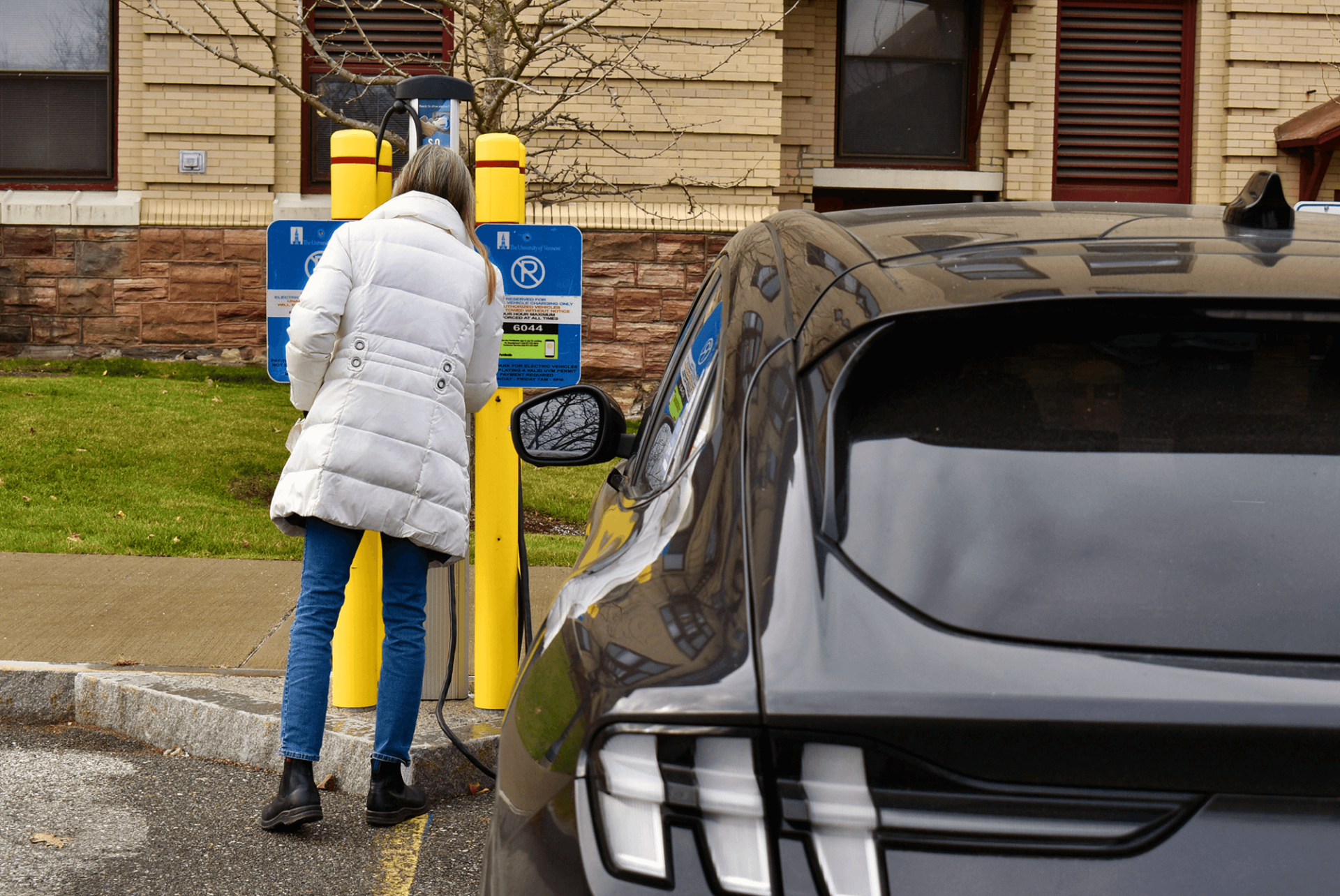 A person paying for EV charging at UVM