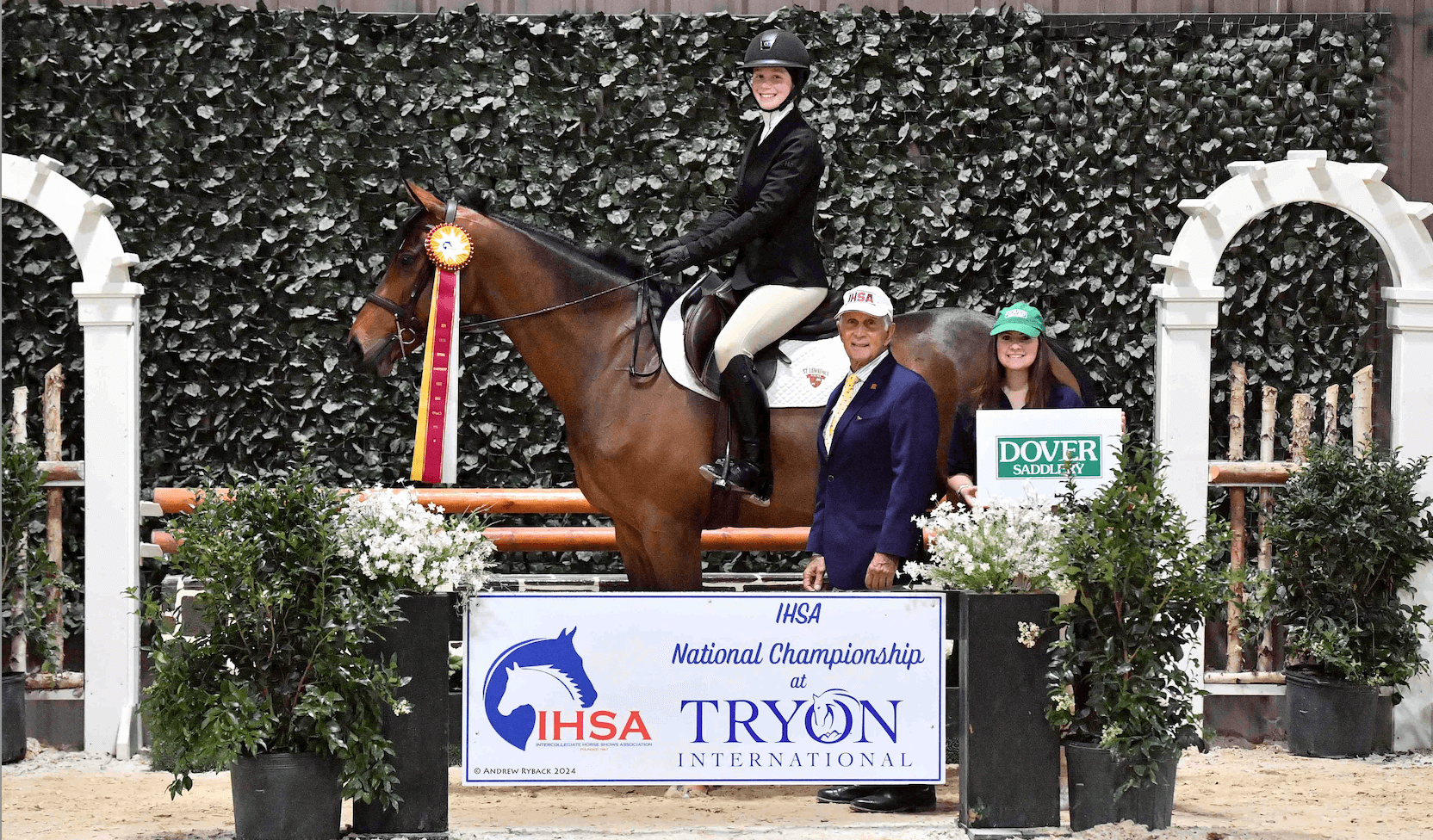 Student sitting on a horse with a national champion ribbon