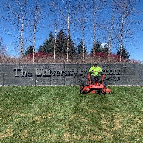 grounds worker sitting on a lawnmower