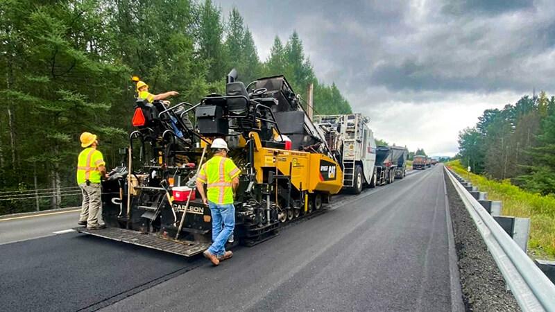 Road crew paving a rural road in Vermont