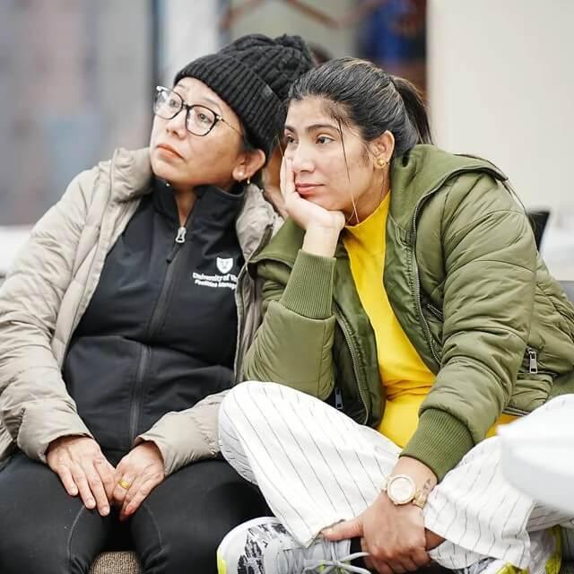 close-up image of two women listening to a training session