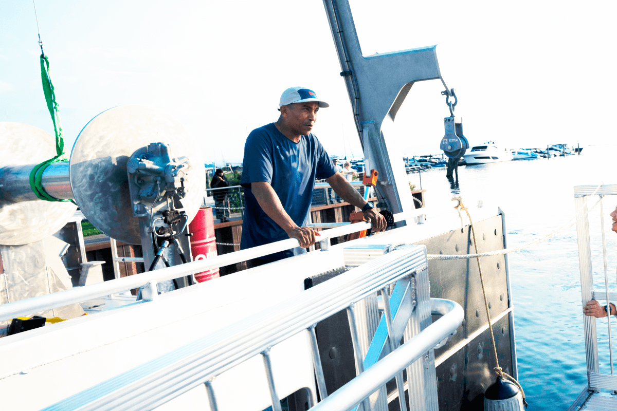 Taylor Resnick standing on the boat looking over the side