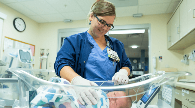 a nurse with an infant in a hospital