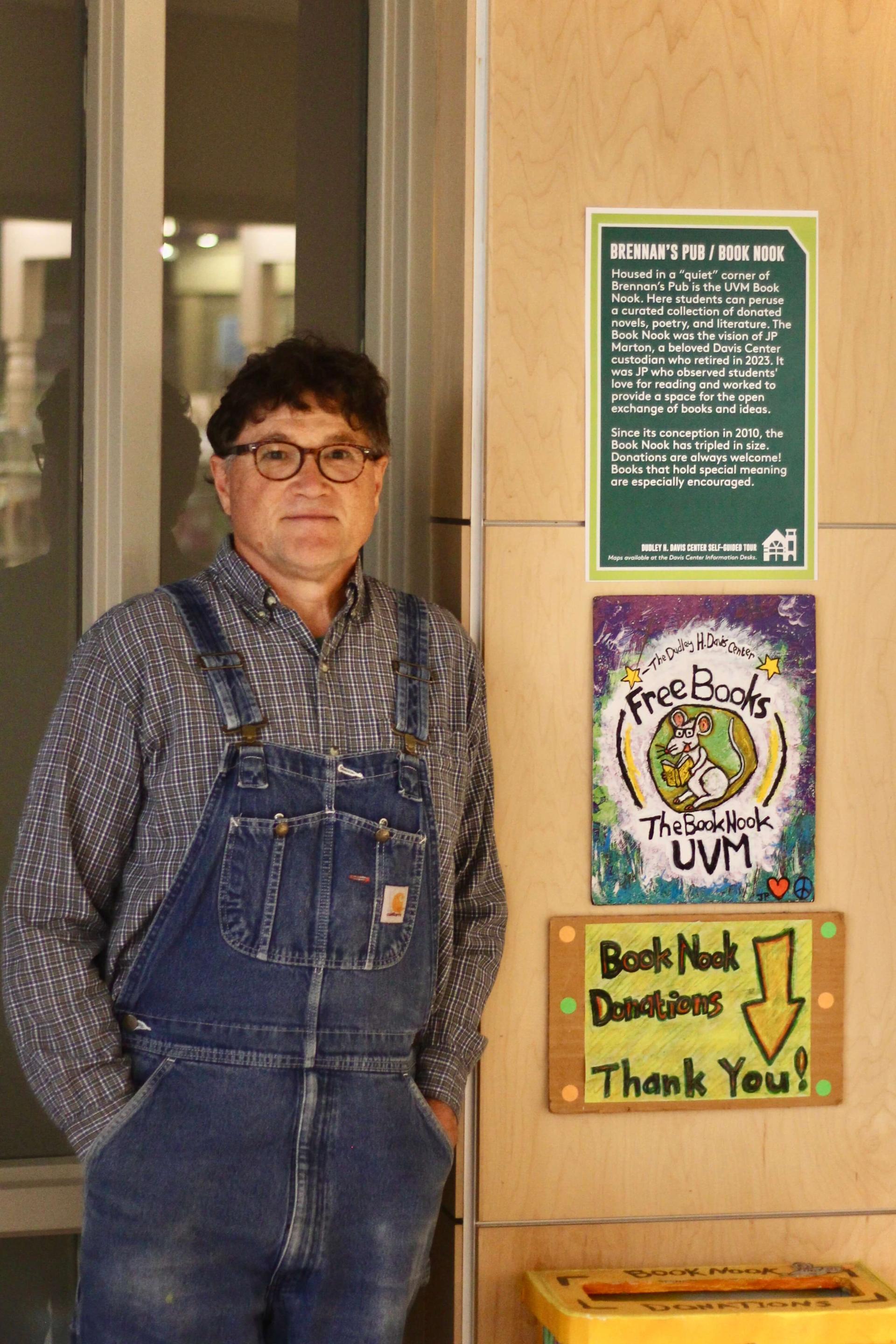 "JP Marton stands in front of a Book Nook collection box, which is decorated with his signature folk art."