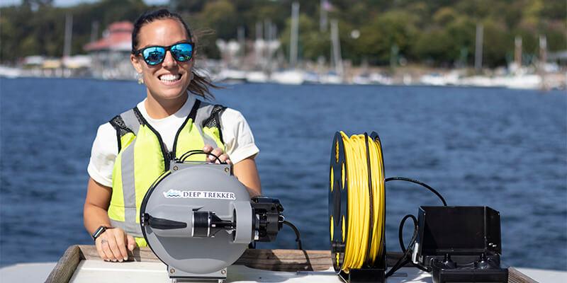 Ashley runs equipment on a research boat on Lake Champlain